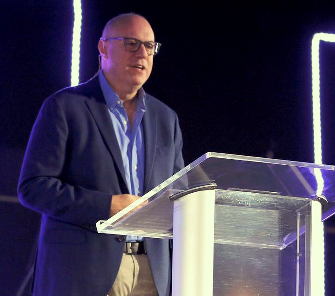 Peter Ramis speaking from a stage